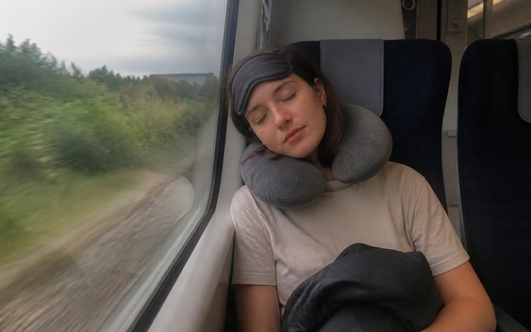 Schlafmaske und Nackenkissen im Flugzeug